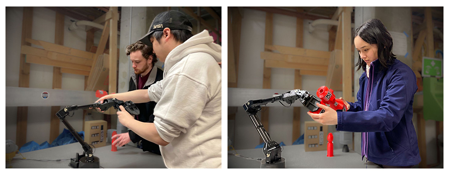 Students setting up a robotic arm