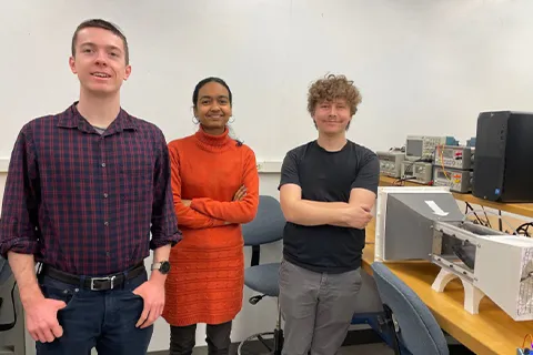 Three people standing smiling to the camera