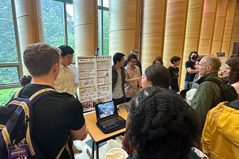 Group of people looking at a poster during a showcase event