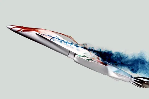 Aerodynamic aircraft model with colored smoke trails illustrating airflow patterns